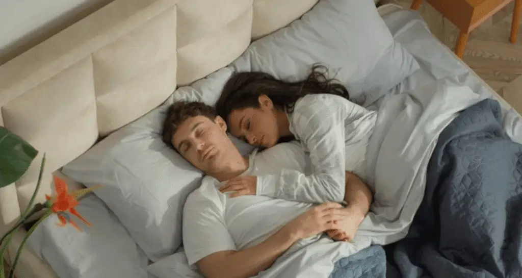 Couple sharing bed peacefully, showing sleeping intimacy as explored by a sleeping scientist