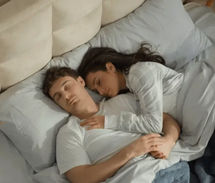 Couple sharing bed peacefully, showing sleeping intimacy as explored by a sleeping scientist