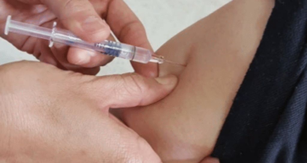 Healthcare professional administering baby vaccination using gentle ways to minimize discomfort during immunization