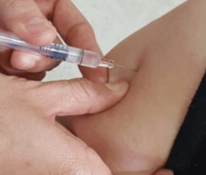 Healthcare professional administering baby vaccination using gentle ways to minimize discomfort during immunization