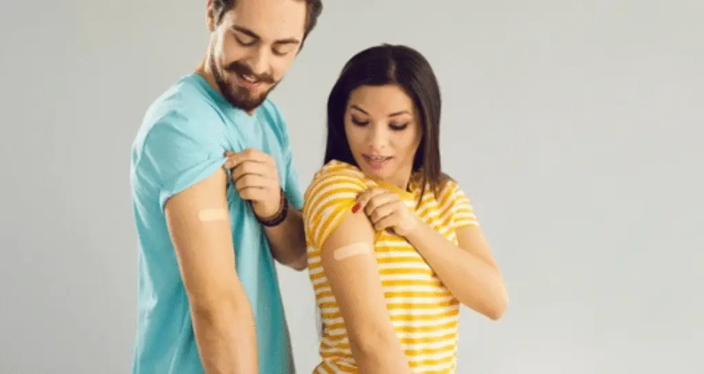 Man and woman smiling while showing arms after receiving FDA HIV prevention shot.