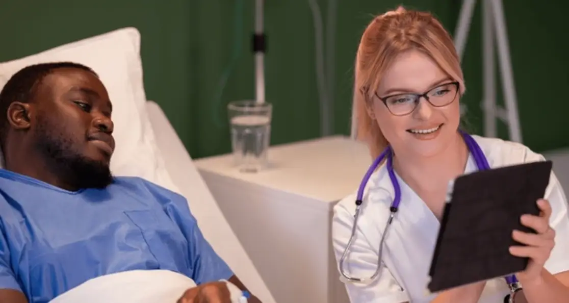 Doctor sharing reliable health information with patient using digital tablet in hospital setting
