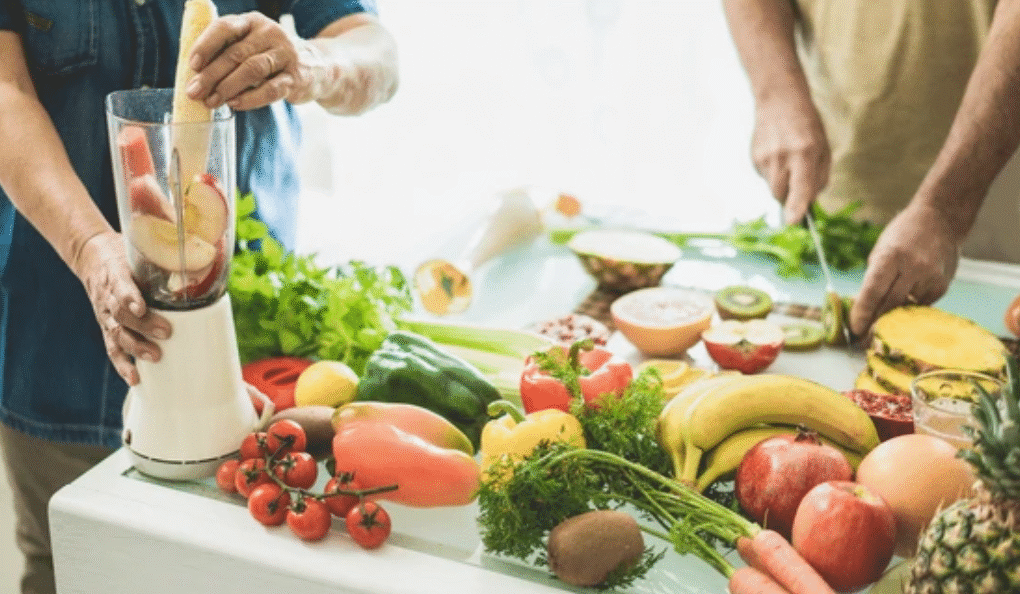 People preparing healthy foods for anti-ageing nutrition with fresh fruits and vegetables to support biological age