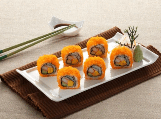 Fresh masago capelin fish roe sushi rolls with orange coating served on white plate showcasing vibrant flavor and texture