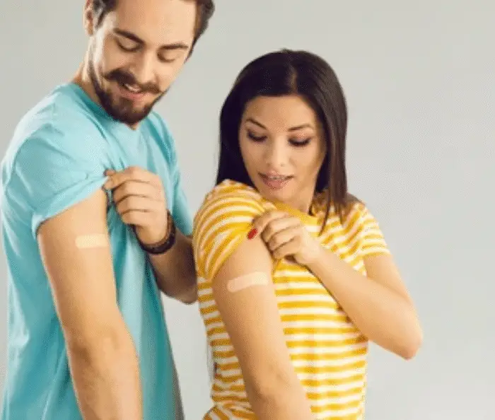 Man and woman smiling while showing arms after receiving FDA HIV prevention shot.