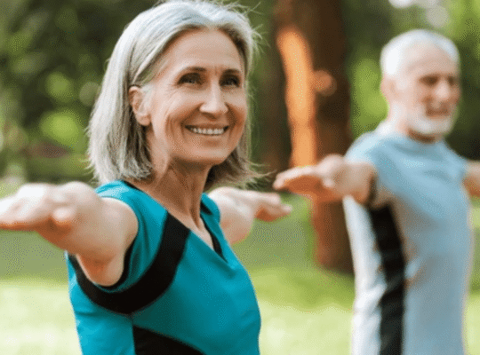 Senior woman practicing yoga energy poses outdoors to restore balance with partner in peaceful park setting
