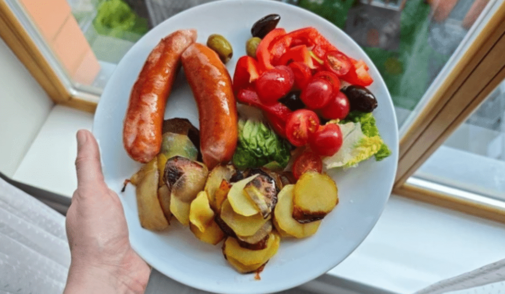 Sausage nutrition meal with grilled sausages, roasted potatoes, and fresh vegetables showing balanced health choices