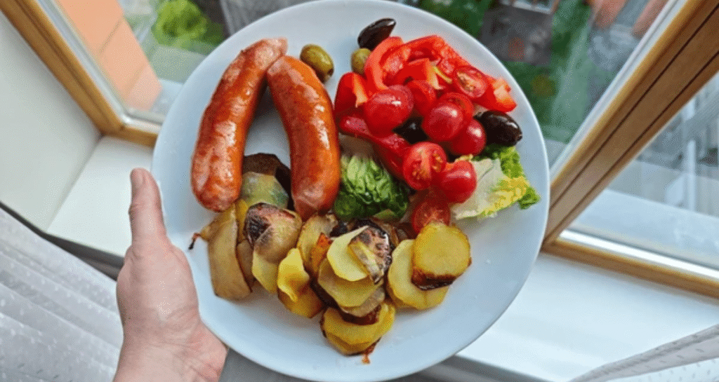 Sausage nutrition meal with grilled sausages, roasted potatoes, and fresh vegetables showing balanced health choices
