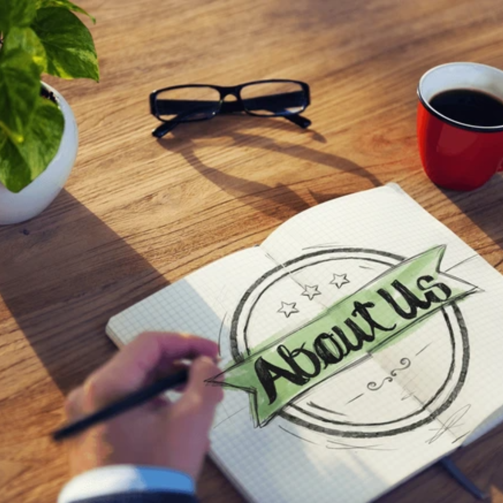 About us page design sketch for Healthy Power Up wellness website on wooden desk with coffee and glasses